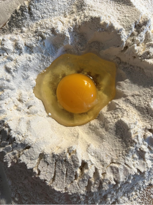 An egg yolk in flour.